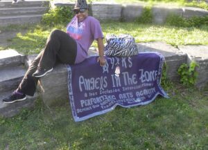 Person relaxing outdoors with a protest sign about animals in the zoo.
