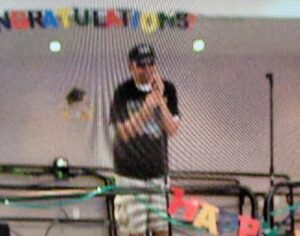 Person taking a selfie in a room decorated with colorful banners.