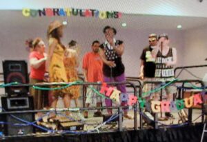 Children and adults celebrate a cheerful birthday party with decorations and cake.