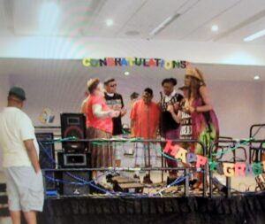 Children enjoy a colorful birthday party with decorations and cake.
