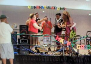 A group performing music on stage at a celebration event.