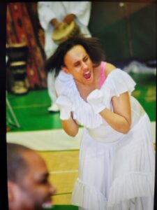 Woman passionately cheering at a sports event.