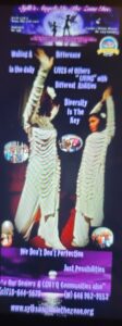 Two women in white dresses dancing under colorful lights.