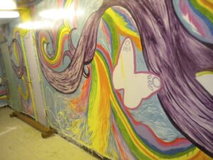 Colorful mural with a white dove and flowing rainbow ribbons.